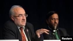 FILE - Michel Jarraud, WMO secretary-general, speaks next to IPCC Chairman Rajendra Pachauri during a news conference in Stockholm, Sept. 27, 2013.