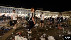 Juventus supporters look for personal belongings at Piazza San Carlo after a panic movement in the fan zone where thousands of Juventus fans were watching the UEFA Champions League Final soccer match between Juventus and Real Madrid on a giant screen in Turin, Italy, June 3, 2017.