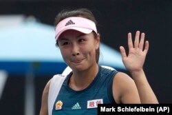 FILE - China's Peng Shuai waves after losing to Canada Eugenie Bouchard in their first round match at the Australian Open tennis championships in Melbourne, Australia on Jan. 15, 2019