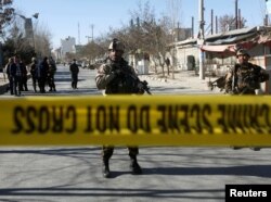 Afghan security forces keep watch at the site of a suicide attack in Kabul, Afghanistan, Dec. 28, 2017.