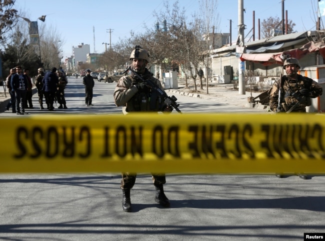 Afghan security forces keep watch at the site of a suicide attack in Kabul, Afghanistan, Dec. 28, 2017.