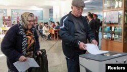 People vote at a polling station during the presidential election in Bishkek, Kyrgyzstan, Oct. 15, 2017.
