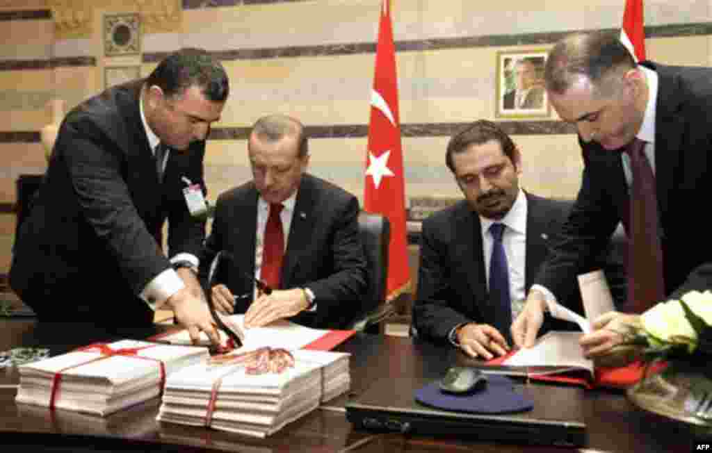 Lebanese Prime Minister Saad Hariri, center right, and his Turkish counterpart Recep Tayyip Erdogan, center left, sign agreements at the Government House in Beirut, Lebanon, Wednesday, Nov. 24, 2010. Erdogan arrived in Beirut on Wednesday on a two-day vis