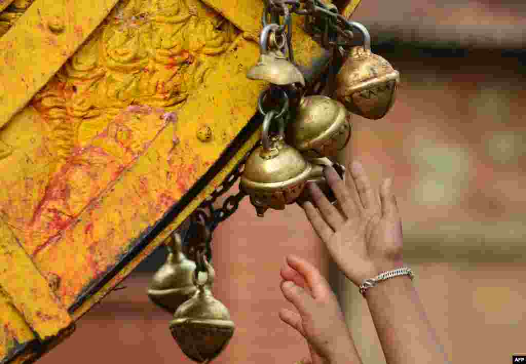 Nepalese revelers ring bells on a wooden chariot during celebrations for the Nepalese New Year or &quot;Bisket Jatra&quot; in Bhaktapur, some 12 kms east of Kathmandu. The festival which began April 10, is celebrated for nine days by the ethnic Newar community in Bhaktapur.