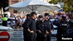 Police officers stand at a road block at the beginning of fiestas in Bilbao, Spain, August 19, 2017.