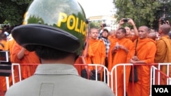 At least four monks and five other people were injured in repeated clashes between demonstrators and police in Phnom Penh Tuesday. 
