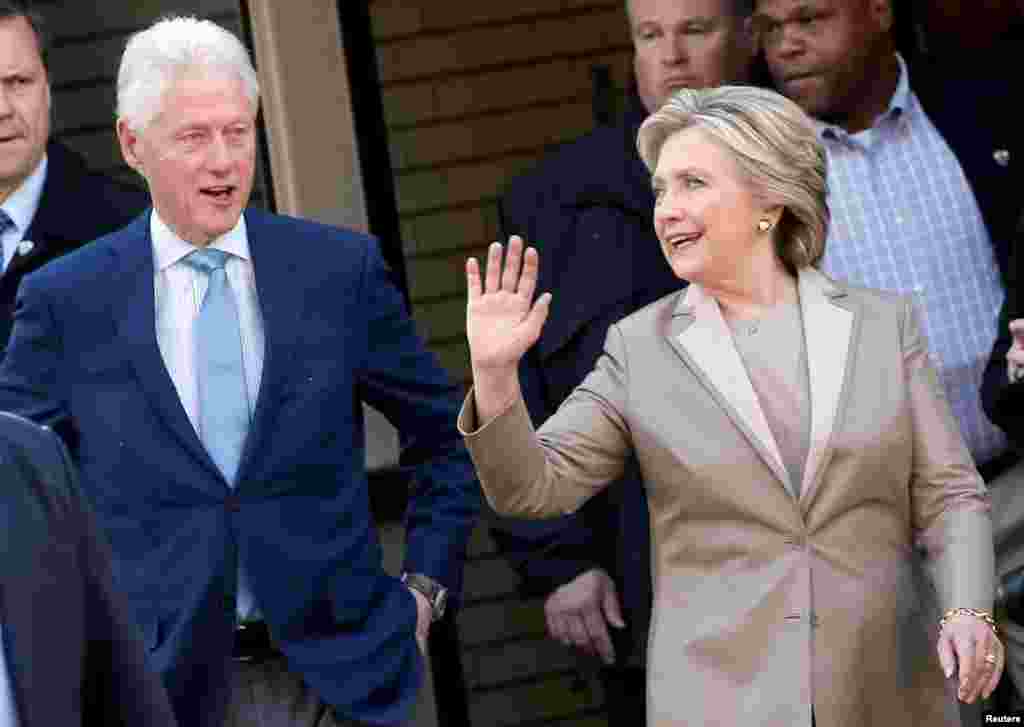 Hillary Clinton and her husband former U.S. president Bill Clinton depart after voting