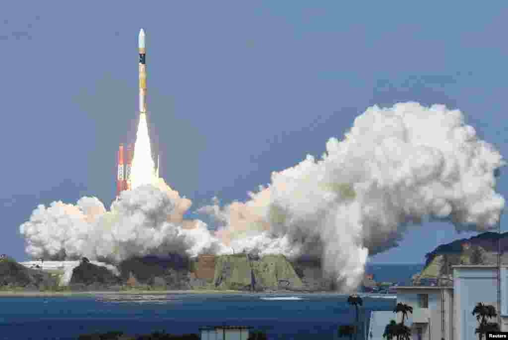 A rocket carrying Himawari 8 weather satellite, takes off from the launching pad at Tanegashima Space Center on the Japanese southwestern island of Tanegashima, in this photo taken by Kyodo. 