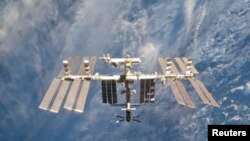 The International Space Station is seen in this view from the space shuttle Discovery. "Technologies for NASA missions have long improved life here on Earth," said NASA Administrator Charles Bolden.