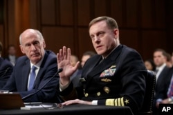 National Security Agency Director Adm. Mike Rogers, center joined by Director of National Intelligence Dan Coats, left, testifies before the Senate Select Committee on Intelligence about gathering intelligence on foreign agents, on Capitol Hill in Washing