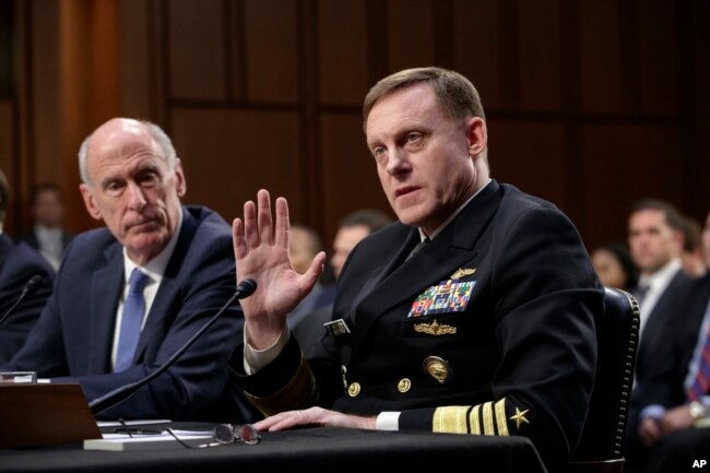 National Security Agency Director Adm. Mike Rogers, center joined by Director of National Intelligence Dan Coats, left, testifies before the Senate Select Committee on Intelligence about gathering intelligence on foreign agents, on Capitol Hill in Washing