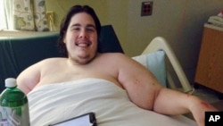 Steven Assanti, 33, rests in bed at a Rhode Island hospital. Assanti, who weighs nearly 800 pounds, said he was kicked out of another hospital for ordering pizza. 