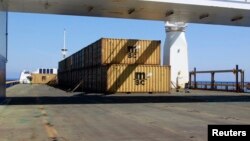 FILE - Containers on the deck of Ark Futura, a Danish-chartered cargo vessel, carry precursors to sarin gas, part of the effort to extract chemical weapon stockpiles from Syria, in the Eastern Mediterranean Sea, May 13, 2014.