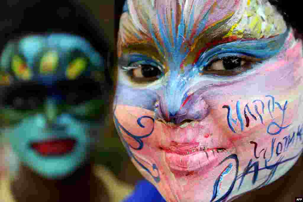 Indian students pose with their faces painted at a college in Chennai ahead of International Women&#39;s Day.