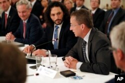 Pat Gelsinger, Chief Executive Officer of VMware, right, speaks during an American Technology Council roundtable in the State Dinning Room of the White House, June 19, 2017, in Washington.