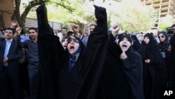 FILE - Iranian protesters chant slogans in front of the Saudi Arabian Embassy in Tehran, Iran, Sunday, Sept. 27, 2015.