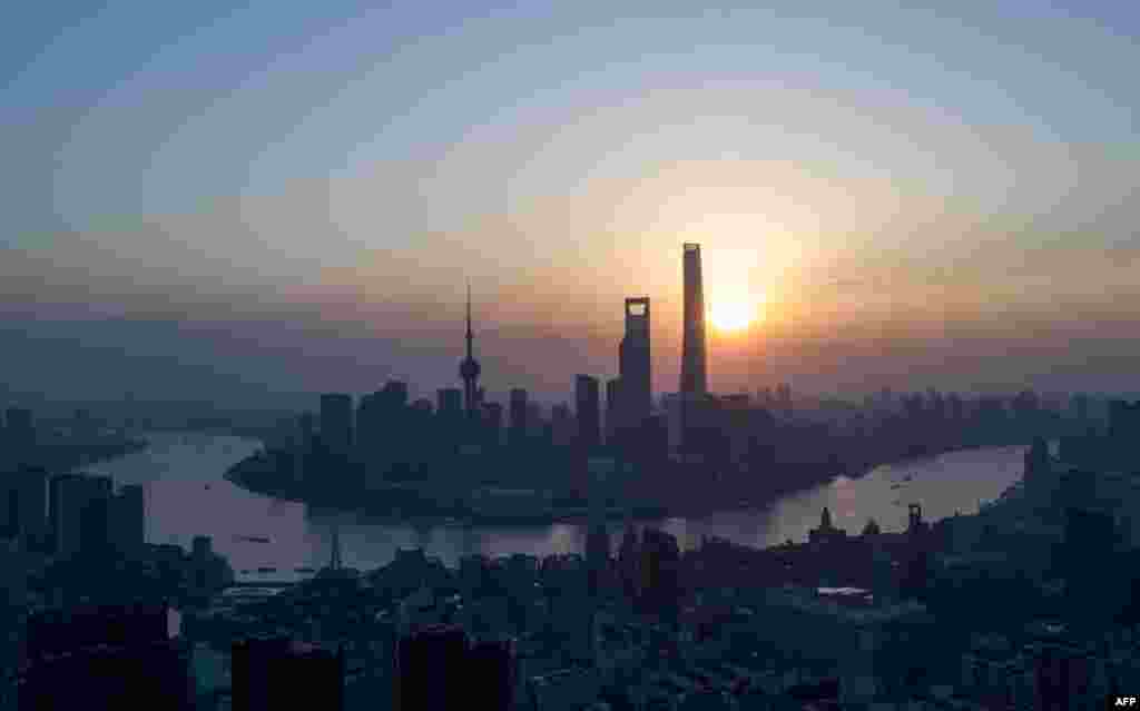 上海黄浦江沿岸陆家嘴金融区，旭日东升。本图集后面还有一张类似场景，在1973年拍摄的照片，作为对比。