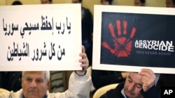 Assyrians citizens hold placards during a sit-in for abducted Christians in Syria and Iraq, at a church in Sabtiyesh area east Beirut, Lebanon, Feb. 26, 2015. 