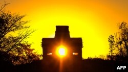 FILE - The sun shines directly through the door of the Seven Dolls Temple, in the Maya Ruins of Dzibilchaltun, in the Mexican state of Yucatan in this March 20, 2017, photo.