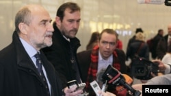 Herman Nackaerts (L) , head of a delegation of the International Atomic Energy Agency (IAEA), speaks to journalists at the airport in Vienna after arriving from Iran, December 14, 2012.