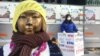 University student Kim So-min, 21, stands in protest outside the Japanese Embassy in Seoul near a bronze statue of a young Korean girl, a reminder of Japan's World War II comfort women. (B. Harrison/VOA ) 
