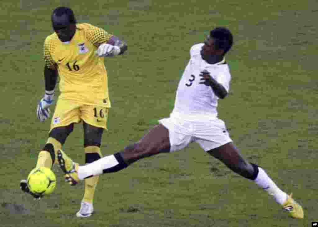 Asamoah Gyan of Ghana (R) fights for the ball with Zambia's goalkeeper Kennedy Mweene during their African Nations Cup semi-final soccer match at Estadio de Bata "Bata Stadium" in Bata February 8, 2012.