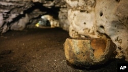 Pre-columbian artifacts sit in a cave at the Mayan ruins of Chichen Itza, Yucatan, Mexico, Tuesday, Feb. 19, 2019. (Karla Ortega/Mexico's National Institute of Anthropology and History via AP)