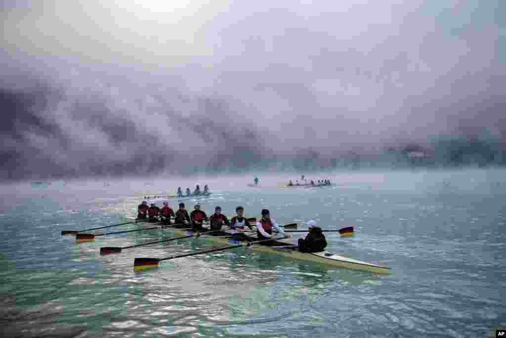 Rowers warm up in early morning fog during the World Rowing Championships in Aiguebelette, French Alps.