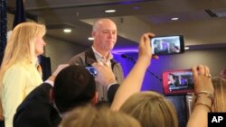 Republican Greg Gianforte greets supporters at a hotel ballroom after winning Montana's sole congressional seat, May 25, 2017, in Bozeman, Mont. In his speech, Gianforte apologized for a altercation at his campaign headquarters with a reporter on the eve of the special election. The altercation led to a misdemeanor assault citation.