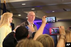 Republican Greg Gianforte greets supporters at a hotel ballroom after winning Montana's sole congressional seat, May 25, 2017, in Bozeman, Mont. In his speech, Gianforte apologized for a altercation at his campaign headquarters with a reporter on the eve of the special election.