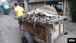 A worker pulls a cart of animal hides. Human Rights Watch has warned of toxic conditions for workers and Hazaribagh's residents. (A. Yee/VOA)