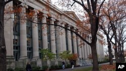 FILE - Students walk through the Harvard Law School area on the campus of Harvard University in Cambridge, Massachusetts. Harvard is one of the Ivy League schools that Nigerian teen Augusta Uwamanzu-Nna, who was accepted to all eight, might attend. 