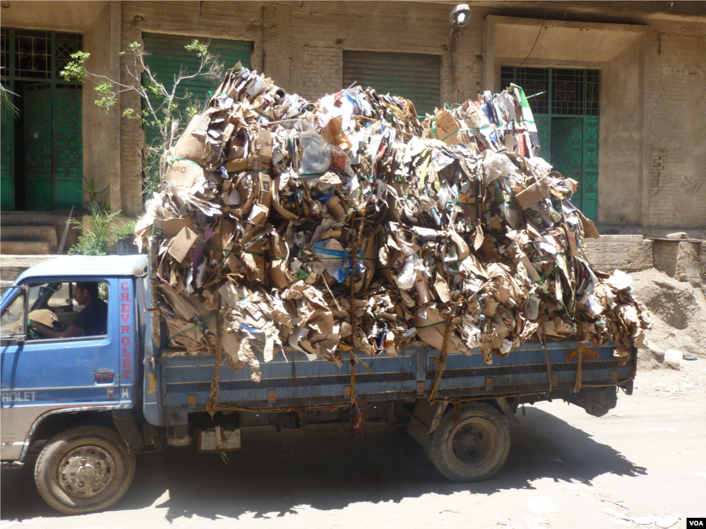 A truck loaded with garbage driving through the Coptic Christian slum area of Cairo known as Garbage City July 18, 2013. (VOA/S. Behn)