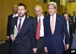 U.S. Secretary of State John Kerry, right, walks with White House senior adviser Brian Deese, left, to meet with French Foreign Minister Laurent Fabius during the climate change conference at Le Bourget, France, Dec. 10, 2015.