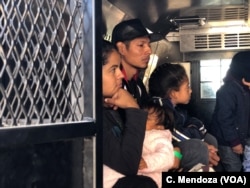 A group of Guatemalan migrants, including five families, waits inside a U.S. Customs Border Patrol truck after being processed at the crossing at El Paso, Texas, April 9, 2019.