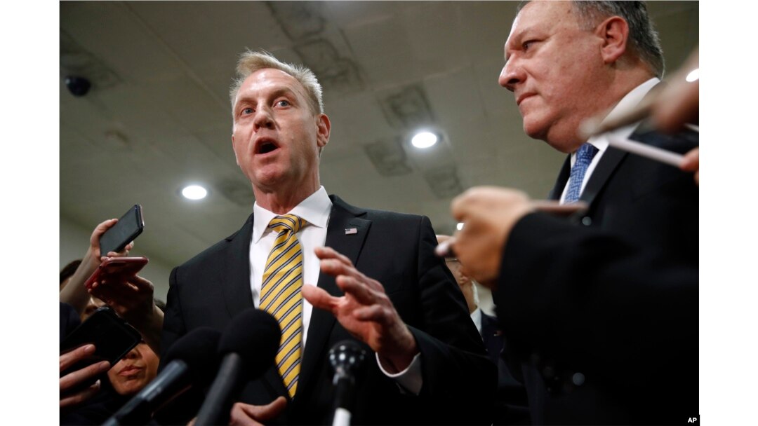 Acting Defense Secretary Patrick Shanahan, left, speaks to members of the media alongside Secretary of State Mike Pompeo after a classified briefing for members of Congress on Iran, on Capitol Hill in Washington, May 21, 2019.