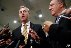 Acting Defense Secretary Patrick Shanahan, left, speaks to members of the media alongside Secretary of State Mike Pompeo after a classified briefing for members of Congress on Iran, on Capitol Hill in Washington, May 21, 2019.