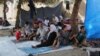 FILE - Displaced Iraqis from the Yazidi community gather at a park near the Turkey-Iraq border at the Ibrahim al-Khalil crossing, as they try to cross to Turkey, in Zakho, 475 km northwest of Baghdad, Aug. 15, 2014.