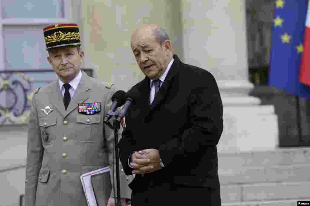 French Defense Minister Jean-Yves Le Drian stands beside French Army Chief of Staff General Pierre Le Jolis de Villiers de Saintignon as they speak to journalists after a crisis meeting at the Elysee Palace in Paris, Jan. 12, 2015.