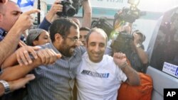 Hagai Amir (R), the brother of the man who assassinated the late Israeli Prime Minister Yitzhak Rabin, rejoices after his release from Ayalon prison, south of Tel Aviv May 4, 2012.