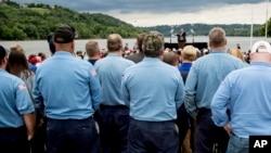 People are seen gathered to hear President Donald Trump as he speaks about infrastructure at Rivertowne Marina in Cincinnati, Ohio, June 7, 2017.