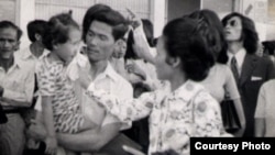 Neou Sarem says goodbye to her husband, Nuon Sari, and her 3-year old daugther, Nuon Sari Sakhura, at Pochentong Airport, 1974.