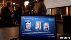 The names of Rainer Weiss, Barry C. Barish, Kip S. Thorne are displayed on the screen during the announcement of the winners of the Nobel Prize in Physics 2017, in Stockholm, Sweden, Oct. 3, 2017. 