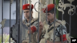 Egyptian soldiers stand guard outside the Maadi military hospital where former president Hosni Mubarak was transferred and is currently on life support, June 20, 2012. 