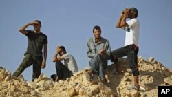 Libyan rebel fighters watch the border at the frontline of Al-Qawalish in the western mountains of Libya, after a battle with forces loyal to Libyan leader Moammar Gadhafi, July 14, 2011