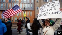 Maria Arellano, who works in Washington and whose parents are from Mexico, carries a sign during a Day Without Immigrants protest in Washington. (AP Photo/Alex Brandon)