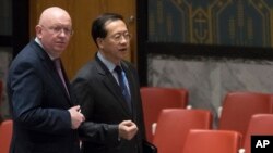 Russian Ambassador to the United Nations Vassily Nebenzia, left, speaks to Chinese Ambassador to the United Nations Ma Zhaoxu before a Security Council meeting on the situation in Syria, at United Nations headquarters, Feb. 23, 2018.