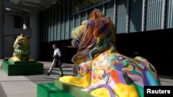 FILE - "Stephen" (L) and "Stitt", the two lions in rainbow colors to show support for the LGBT (lesbian, gay, bisexual and transgender) community, are newly displayed at HSBC's main branch in Hong Kong, Dec. 7, 2016. 