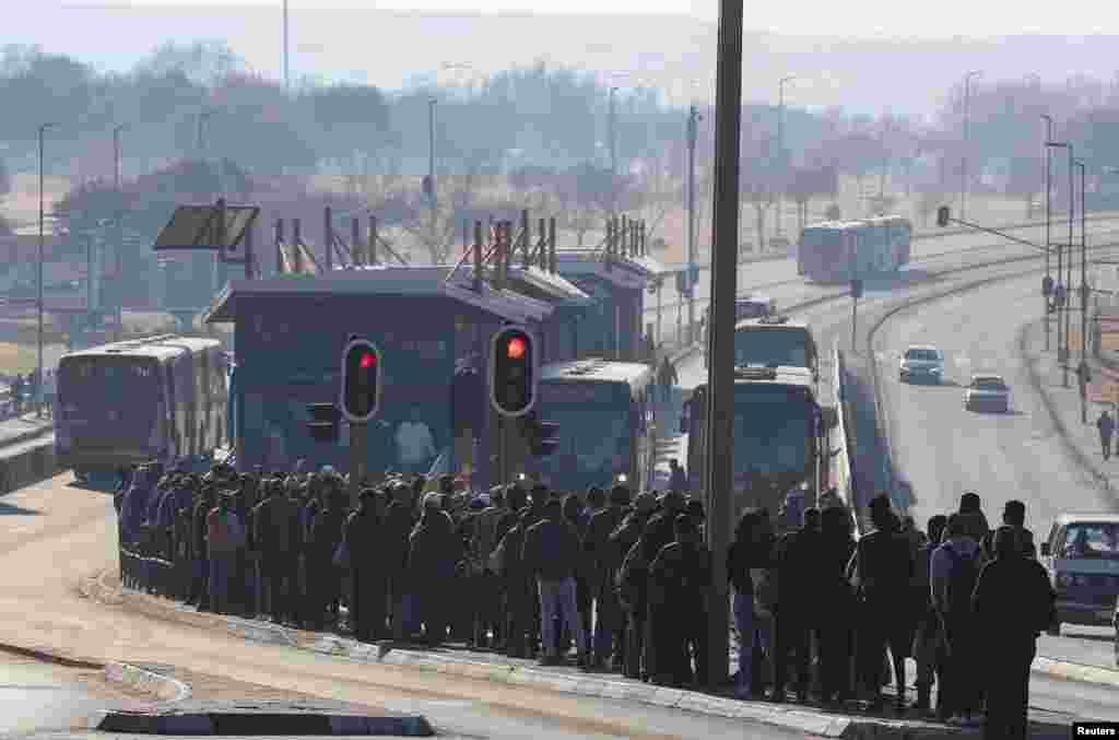 Buses are seen as stranded commuters wait for transportation at a bus terminal during a protest by taxi operators over the government&#39;s financial relief for the taxi industry, amid the coronavirus disease (COVID-19) lockdown, in Soweto, South Africa.