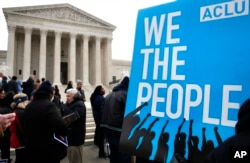 FILE - People rally outside of the Supreme Court in opposition to Ohio's voter roll purges in Washington, Jan. 10, 2018.